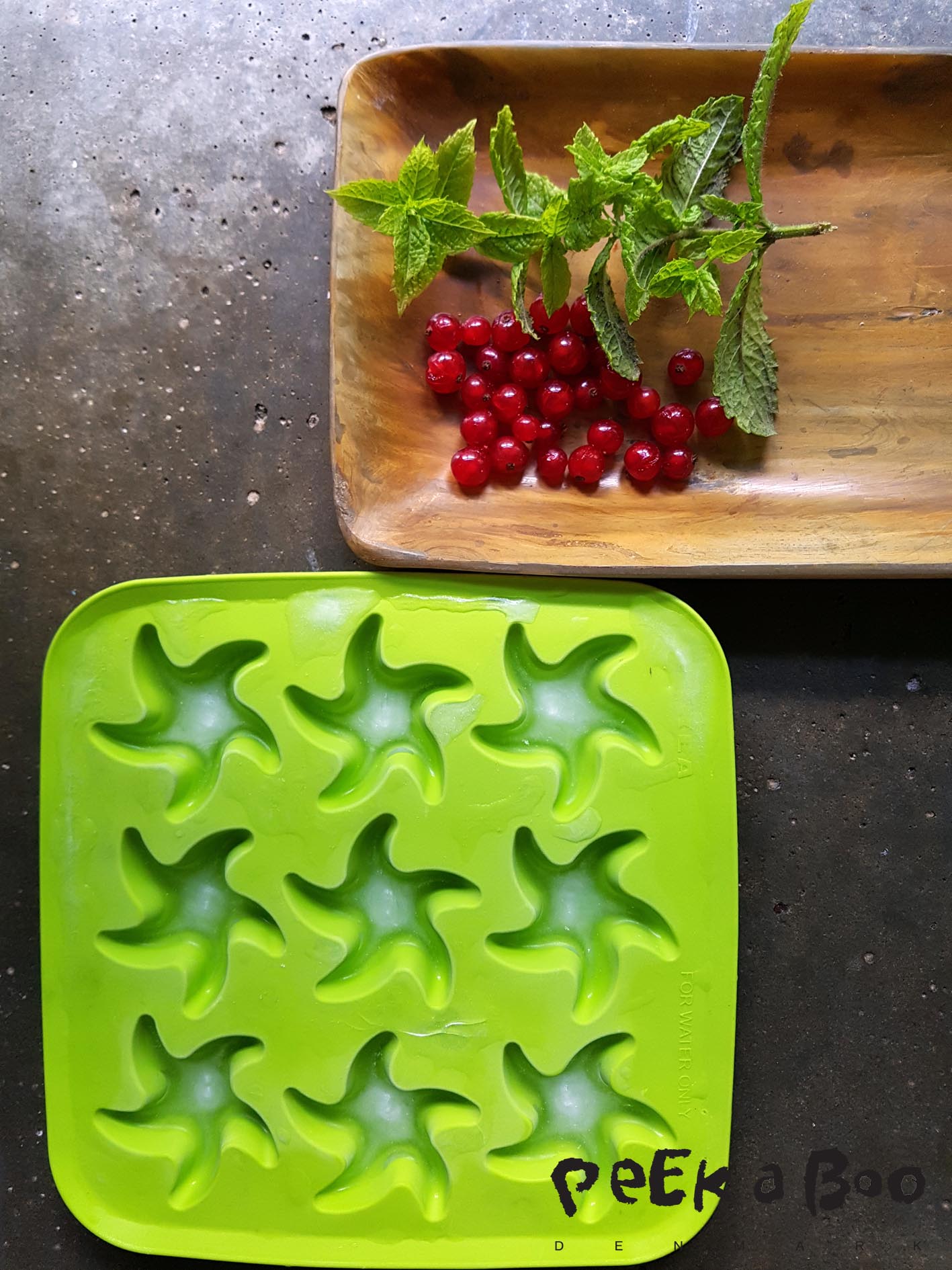 Freeze the botom of the icecubes. Use small berries and mint leaves.