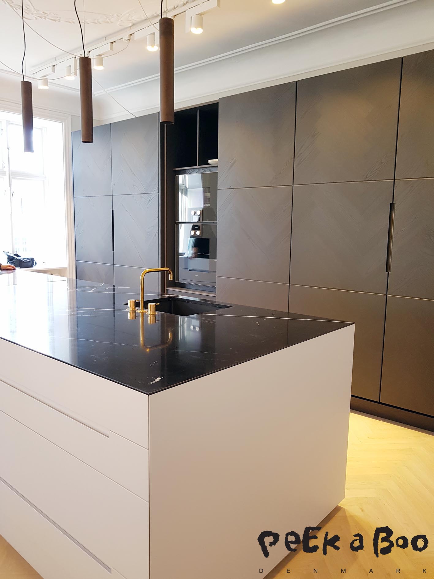 The closed kitchen with the dark wood and black Italian marble. 