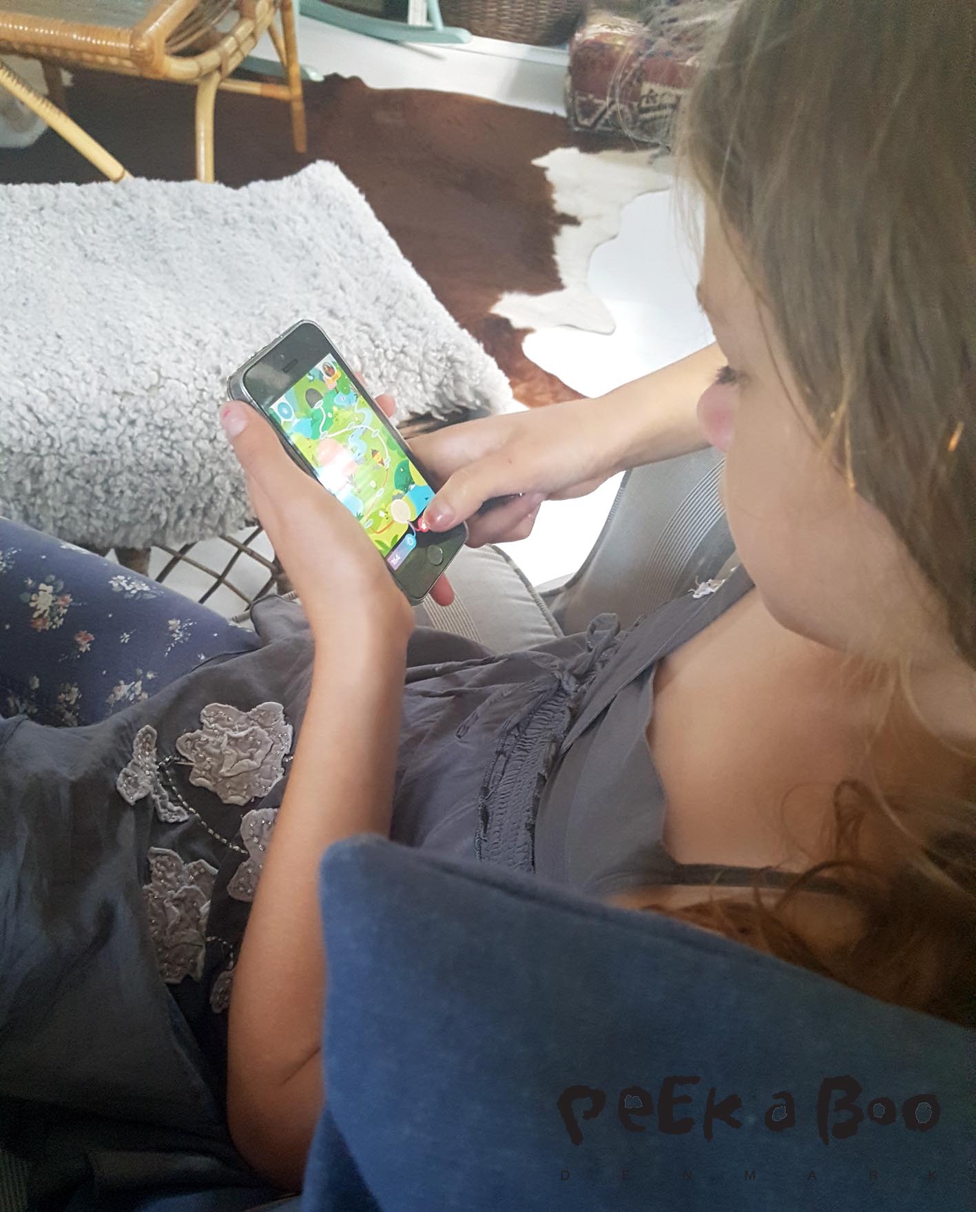 Flora is checking how far she can go in her ReimaGo app. after being active.