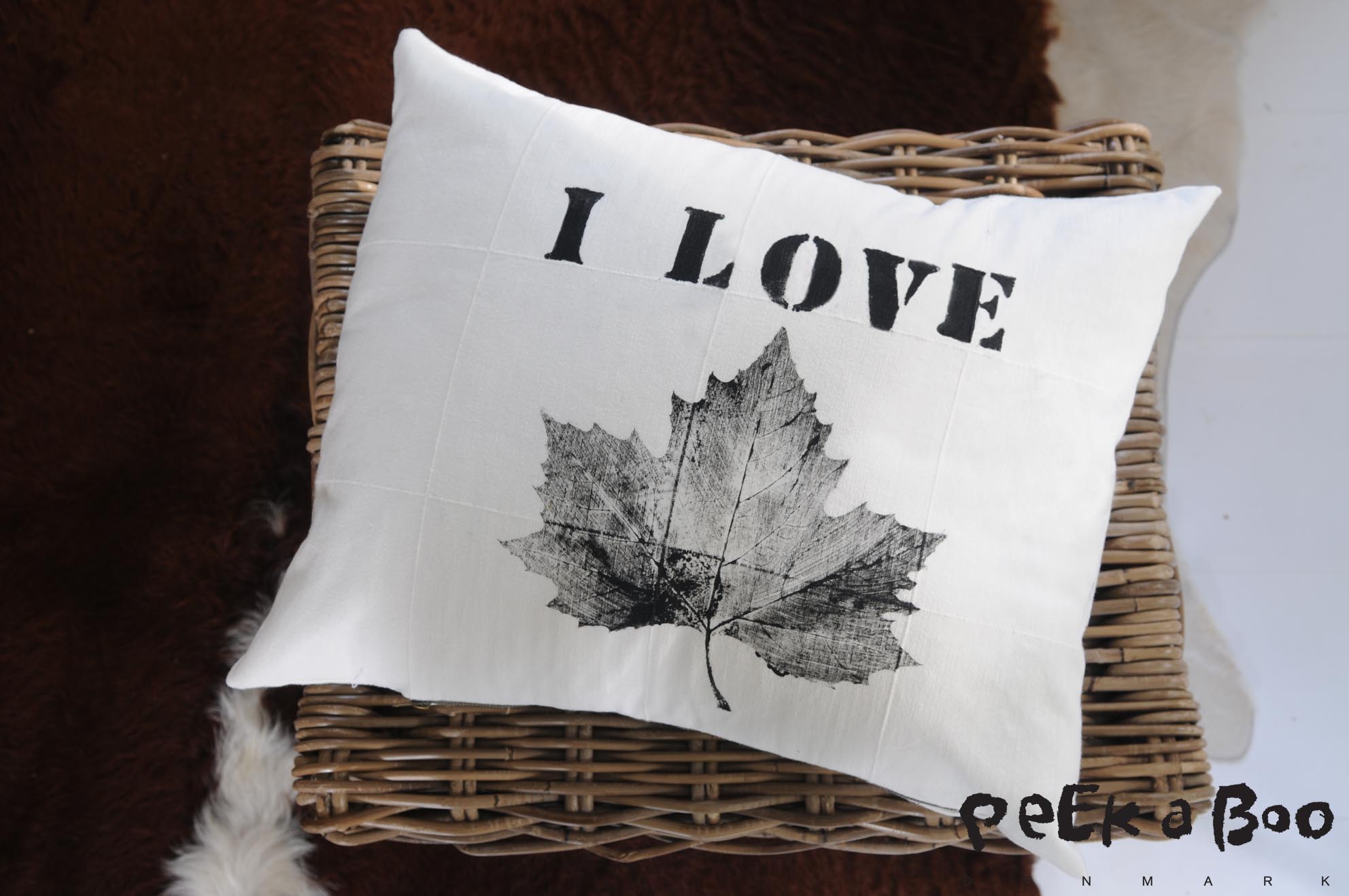 Pillowcase printed with leaf and stencil letters.